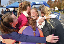 Family and friends making up the Speedy Chicks team, from left, Julia ReSele, Coyla Bartholomew, Victoria Bartholomew, Hannah Bartholomew, Tina Bartholomew and Grace Petrick hug after crossing the finish line in the annual Run for the Diamonds in Bewick Thursday morning. The team took first place in the female division.