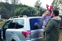 Micah Melbie and his daughter Lorelai, 3, head home to Williamsport after purchasing a Christmas tree at the Bloomsburg Christmas Barn in Catawissa Township Friday.