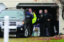 Tom Ambrosia speaks with state troopers and dog officers outside his home.