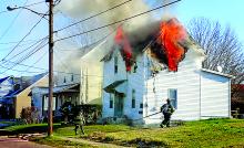 Flames roll out of second-floor windows of a house on Fifth Avenue in Berwick