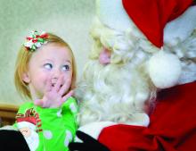 Lily Campbell talks with Santa Claus Sunday morning at the Bloomsburg Fire Company