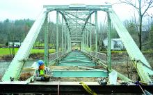 Greg Donaldson prepares to cut some of the old bolts from the Fisher Run Road Bridge