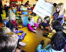 Children play the dreidel game during a Hanukkah celebration at Saint Cyril Academy Preschool and Kindergarten in Danville.