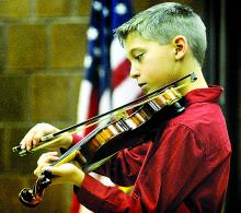 Chase Petro plays Ashokan Farewell on violin during the Winter Fantasy concert