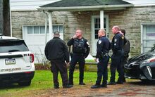 Press Enterprise/Jimmy May Officers from Scott and South Centre Townships along with members of the Columbia County Sheriff’s department stand in the front yard of 3630 Old Berwick Road in Scott Township after a woman was found dead on the porch Wednesday.