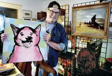 Tom Byrn, top photo, displays a painting by artist R. Land at his home in Berwick on Sunday. “Loss Cat” became an Atlanta, Georgia, icon when he went missing in 2001, a note taped to the back of the artwork says. Byrn will include the painting in his thrift store finds exhibit Friday at Caldwell Consistory in Bloomsburg.