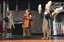 Maurice, played by Julianna Pochatko, at left, is greeted by Cogsworth, played by Cameron Wanner, and Lumiere, played by Wilmar Lewis, during rehearsal for "Beauty and the Beast" at Benton High School.