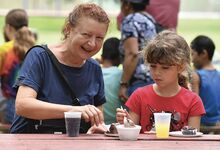 Larysa Sheremeta, left, shares a piece of cake with her granddaughter, Alexia Long, at the 67th Annual Cake and Ice Cream Festival Thursday evening at Town Park in Bloomsburg.