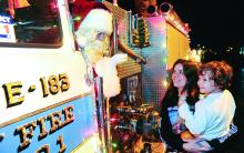 A.J. Franklin collects a bag of treats from Santa on the Espy Fire Engine