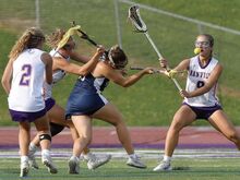 From left, Danville’s Lucy Pickle watches as Addy Palm causes Wyomissing’s Molly Macrina to lose control of the ball in front of Danville’s Paige Biddinger during the second quarter of Tuesday evening’s game in Danville.