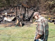 Joe Bucanelli Jr., 73, assesses losses to his large two-story garage and shed in an overnight fire Sunday in Bear Gap near Elysburg