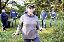 Joan McCarty, with the Kocher Park Committee and the Columbia County Conservation District, leads a group of PPL volunteers, pointing out places that need attention. The group from PPL was at Kocher Park as part of the United Way's Day of Caring.