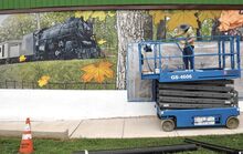 Artist Jonathan Laidacker is installing a mural on the Canal Park side of Beiter’s Department Store on Mill Street in Danville.