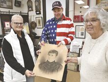 Jim Bach, with the Historical and Preservation Society of the Greater Shickshinny Area, center in the top photo, returns a WWI- era drawing of Hazel Hack to two of her granddaughters, Lana Chyko, left, and Colleen Randolph, on Monday in Shickshinny.