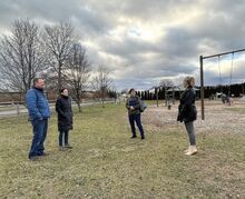 Salem Township Receptionist Ginger Samsel, far right, shows, from left, Philip Geiser, Heather Geiser and Sandra Buck an area to consider for a new wheelchair-accessible swing.