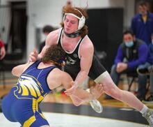 Southern Columbia’s Wesley Barnes leaps off of his feet as Line Mountain’s Jacob Feese shoots in on his leg in the second period of their 215-pound match Wednesday night at Southern.