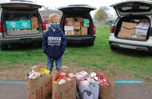 Emery Jones, 6, stands among the more than 1,300 donated food items he collected. He was about to unload them at the Teen Center in Briar Creek Township.