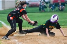 Vo-Tech’s Shelby Welkom, slides safely into third base as Benton’s Rylee LeValley tries to tag her in the second inning Monday at Vo-Tech.