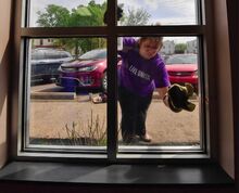 Karyn Migliosi washes windows as several of her co-workers from First Columbia Bank do projects at the Berwick Area YMCA. They took part in the Berwick Area United Way Day of Caring, an annual day of volunteerism. Participants helped spruce up local non-profits, parks and public space. They did yard work, painting and other chores.