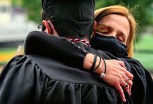 Jackie Lithgow gets a hug from his mom, Lisa, before he goes out on the field at Redman Stadium for Bloomsburg University graduation Sunday. Jackie suffered a severe brain injury when he was a freshman in 2014.