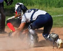 Berwick’s catcher Maddie Auchter, right, gets the tag on Honesdale’s Ciara Young for the out as Young kicks the ball from Auchter’s glove during the second inning of Thursday afternoon’s game in Honesdale.