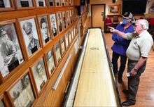 Danville American Legion Post 40 members Dave Callahan, left, and Dean VonBlohn talk about veterans who gave their lives in service. Their names and photos are on the post’s wall in remembrance of their ultimate sacrifice. P