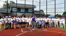 Mike Miller, Berwick Junior Legion manager, center, stands with players, former players, friends and family during a special tribute to him before the start of the state tournament game Saturday.