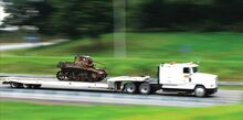 Don's Truck Trailer and Auto Repair hauls a Stuart Tank to the Bloomsburg Fairgrounds this week so that it can go on display outside the Educational Building during fair week.