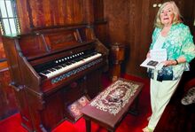 Meg Geffken stands with the Packer organ in St. Gabriel’s Church outside Benton. The chapel organ waskept for years at the Colonel Ricketts estate at Lake Ganoga before it was given to the church and brought back by cemetery association members in August.