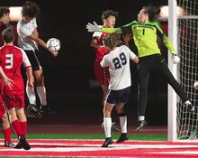 Central Columbia’s Peter Lanza, second from left, heads the corner kick to the feet of Bloomsburg’s Brayden Zeisloft, second from right top, Central’s Steven Brink, second from right bottom and Bloomsburg’s goalkeeper Hughie Curran during the first hald of Monday night’s game at Bloomsburg. Central Columbia beat Bloomsburg, 1-0.