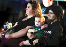 Danville residents Tanya and Carl Gallagher brought their 1-year-old son, Carl Jr., to listen to speakers at Tues- day’s candlelight vigil for domestic violence victims. It was held at the Berwick Theater and Center for Community Arts.