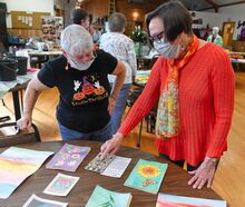 Marcia Farver, at right, talks about watercolor art with Dale Haag during the Berwick Senior Citizen Center Open House Wednesday morning.