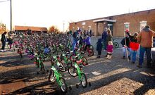 For the Cause volunteers help kids pick out the right-size bicycle during a Christmas giveaway at the Teen Center in Berwick on Saturday. Organizer Josh Nespoli said For the Cause used $32,000 to purchase 167 new bicycles, along with helmets and lights, for area children. Of that money, $20,000 came from one “Secret Santa” donor, he said.