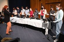 Central Columbia High School Choral Director Tara Smargiassi, at left, directs bell ringers during rehearsal Wednesday. The 2021 holiday concert, “Back Home at Christmas,” is set for Friday in the high school auditorium. Doors open at 6:15 p.m. The middle school concert starts at 6:30 and the high school show is to follow.