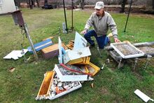 Larue Shultz, 81, Kaseville, shows off a wrecked honeybee hive Monday morning. It was destroyed by a black bear at his Frosty Valley Road home. Shultz, who has had the hives for 18 years, thinks the same black bear was in his yard Oct. 17, but some motion lights probably scared him off. “I use the hive for honey for the family. I got three and a half gallons out of this hive this year.”