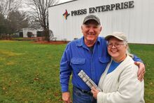 Gary and Nancy George smile in front of the Press Enterprise building in Bloomsburg on Thursday afternoon. The couple is retiring today after delivering the newspaper for 41 years.