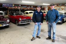 Nelson Creasy, right, and son Tim stand with some of the Hudsons at Creasy’s Garage in Scott Township. The family business closed Jan. 1.