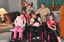 MEMBERS OF THE HARTMAN FAMILY are shown in their Berwick home. They are, from left, front row: Belle Hartman, 12; Treasure Hartman, 10, and Malani Hartman, 10; back row: Nicole Hartman holding Gracie Hartman, 4, and Samantha Hartman, 22.