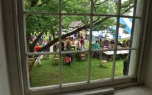 People standing in line for ice cream are seen through the windows in the Warrior Run church on Sunday during the annual strawberry festival.