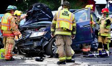 Firefighters work on the Honda Odyssey involved in Friday’s three-vehicle collision on Route 11 at the intersection with Grovania Drive in Montour Township.