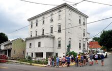 The Washingtonville history walk stops at the former Excelsior Hotel, now an apartment house. John Marr told the folks on the walk the first floor of the building was the bar, and the second floor was a restaurant. There were rooms on the third floor, and the top floor was the ballroom where traveling vaudeville acts would perform.