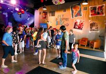 Folks gather in the lobby of the LCBC Columbia-Montour, in photo at left, decorated in the theme of the animated movie “Up,” before the start of Sunday’s featured movie “King Richard.”