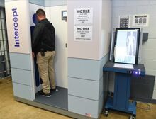 A Columbia County Prison corrections officer demonstrates the procedures for the body scanner at the prison Tuesday afternoon.