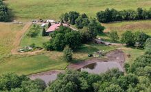 The Department of Environmental Resources works with State Police on draining a pond at a property along Cann Road in Huntington Township on Tuesday. Law enforcement agencies searched the site of a 52-year-old disappearance. Two small excavators were used at the pond.