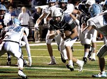 Berwick quarterback Matt Lonczynskicarries the ball into the end zone for a touchdown against Dallas at Crispin Field on Friday night. Berwick won, 39-22.