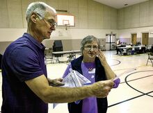 County voting machine operator Bruce Guenther, at left, and Salem Township Judge of Elections Phyllis Dietterick look over paper ballots as they work to fix the paper problem at the Berwick Assembly of God polling place in Salem Township on Tuesday.