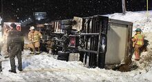 Awinch, above, stabilizes a box truck after an accident on Route 11 Tuesday night as crews work to free the driver in Mahoning Township