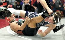 Central Columbia's Alex Hosler, top, and Towanda’s Rylee Sluyter battle for control during their 139-pound consolation bout during District 4 Class 2A wrestling championships at Williamsport High School on Saturday. Hosler won 7-2.