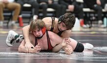 Bloomsburg University’s Caden Dobbins attempts to pin Lock Haven’s Eric Alderfer during Sunday’s match at Nelson Field house at Bloomsburg University. The Huskies fell to the Bald Eagles, 35-9.